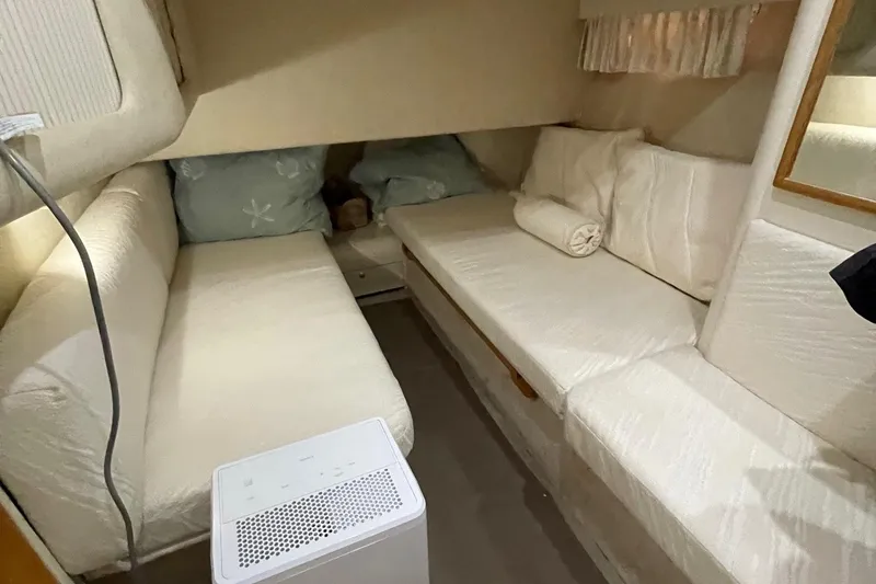 Slide: The Image of Interior cabin of 1997 Sea Ray 400 Sedan Bridge with cozy seating and cushions. - 20