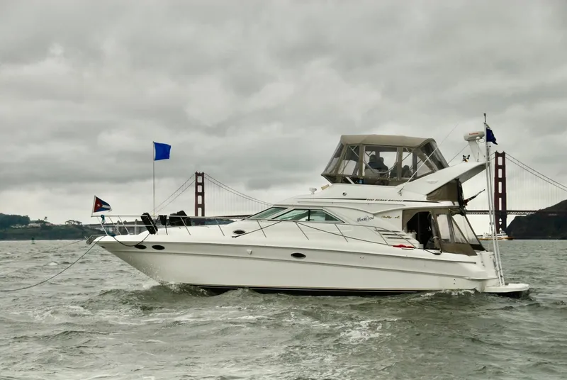 Slide: The Image of 1997 Sea Ray 400 Sedan Bridge yacht near Golden Gate Bridge on cloudy day. - 5