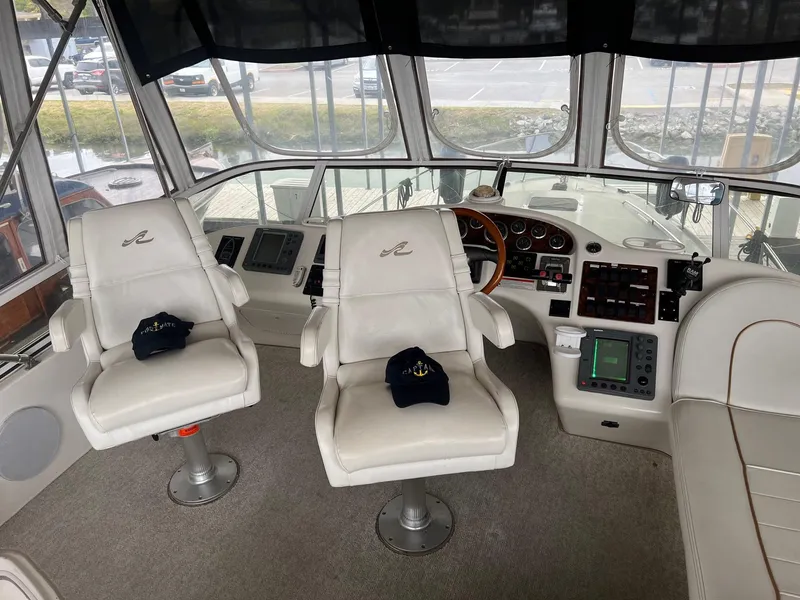 Slide: The Image of Interior of 1997 Sea Ray 400 Sedan Bridge with helm and seating area. - 6