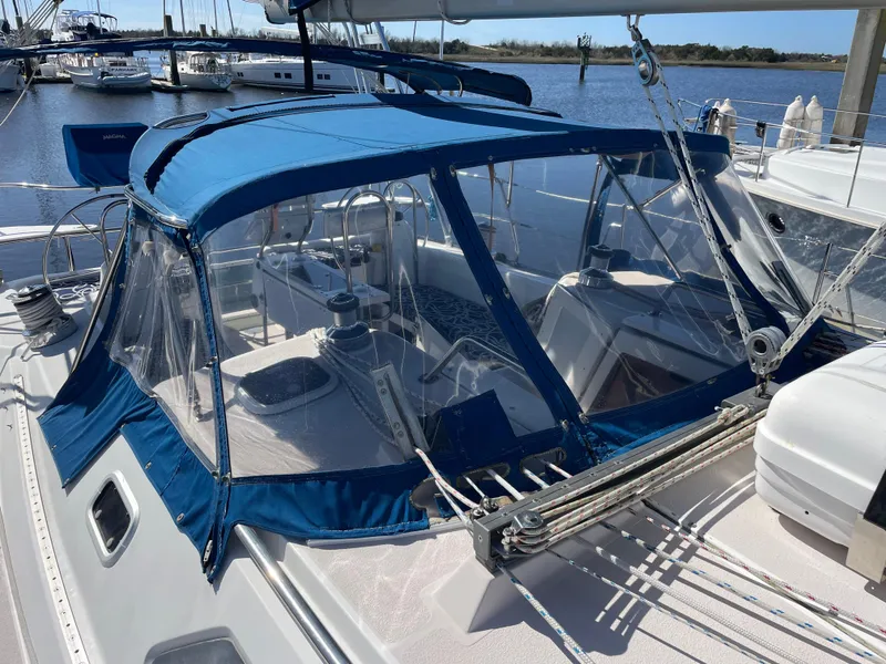 Slide: The Image of 1998 Catalina 400 sailboat with blue canopy docked at marina. - 12