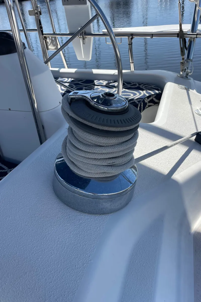 Slide: The Image of Winch on 1998 Catalina 400 sailboat deck, with coiled rope and marina background. - 21