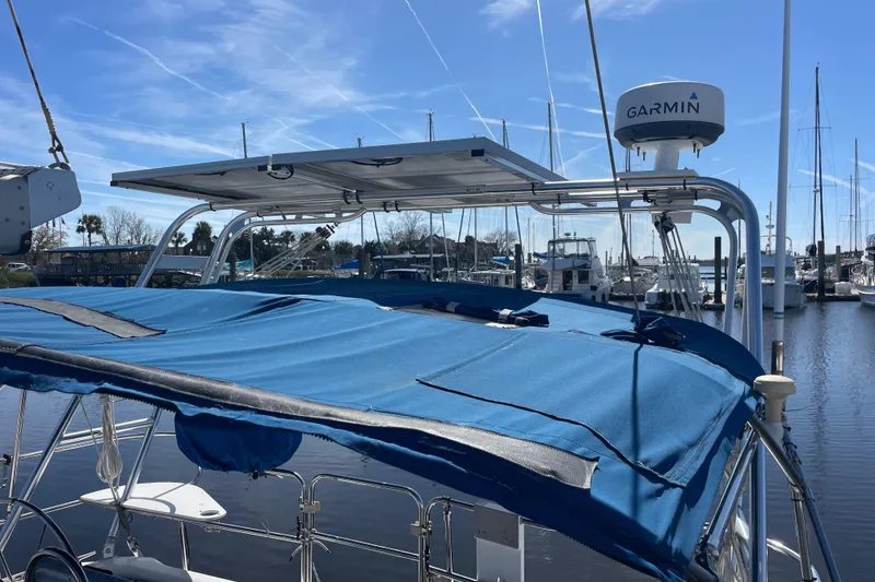 Slide: The Image of Catalina 400 sailboat, 1998 model, with blue cover and Garmin radar, docked at marina. - 23