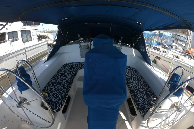 Slide: The Image of Cockpit of a 1998 Catalina 400 sailboat with blue seating and dual steering wheels. - 24