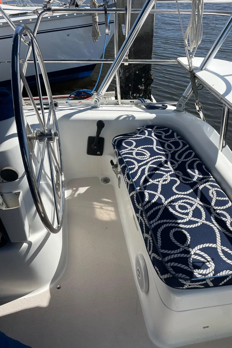 Slide: The Image of 1998 Catalina 400 yacht cockpit with nautical-themed cushion and steering wheel. - 29