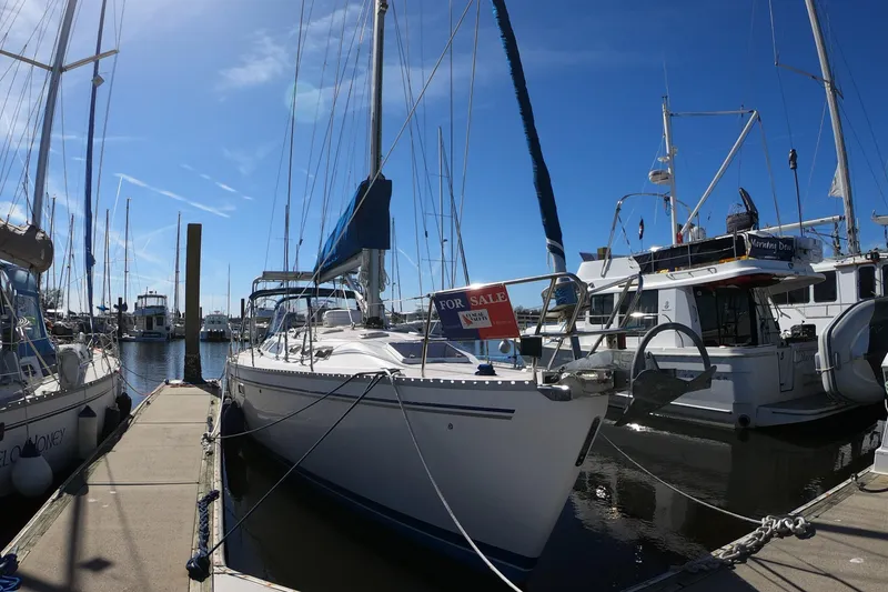 Slide: The Image of Sailboat Catalina 400, 1998 model, docked with "For Sale" sign, under clear blue sky. - 3