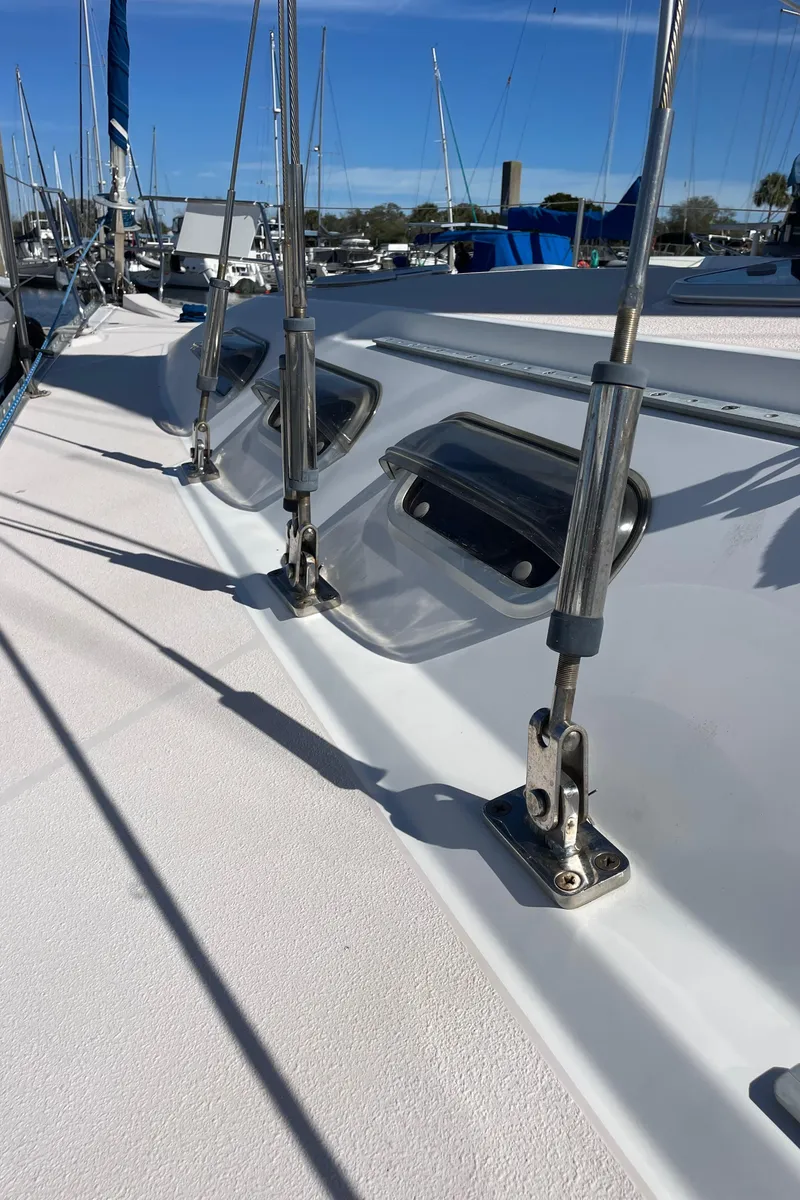 Slide: The Image of 1998 Catalina 400 sailboat deck with rigging and hatches, docked in a marina. - 34