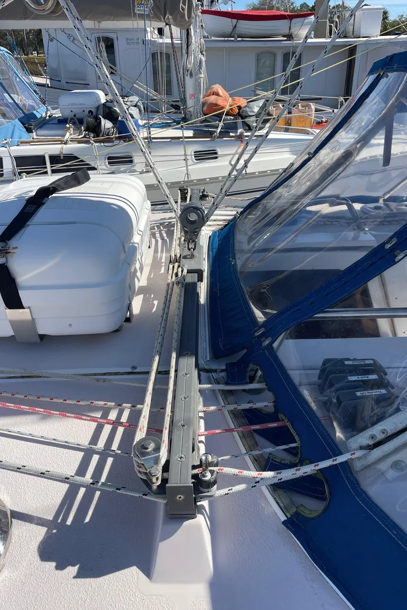 Slide: The Image of Deck view of a 1998 Catalina 400 sailboat, featuring rigging and a blue canopy. - 35