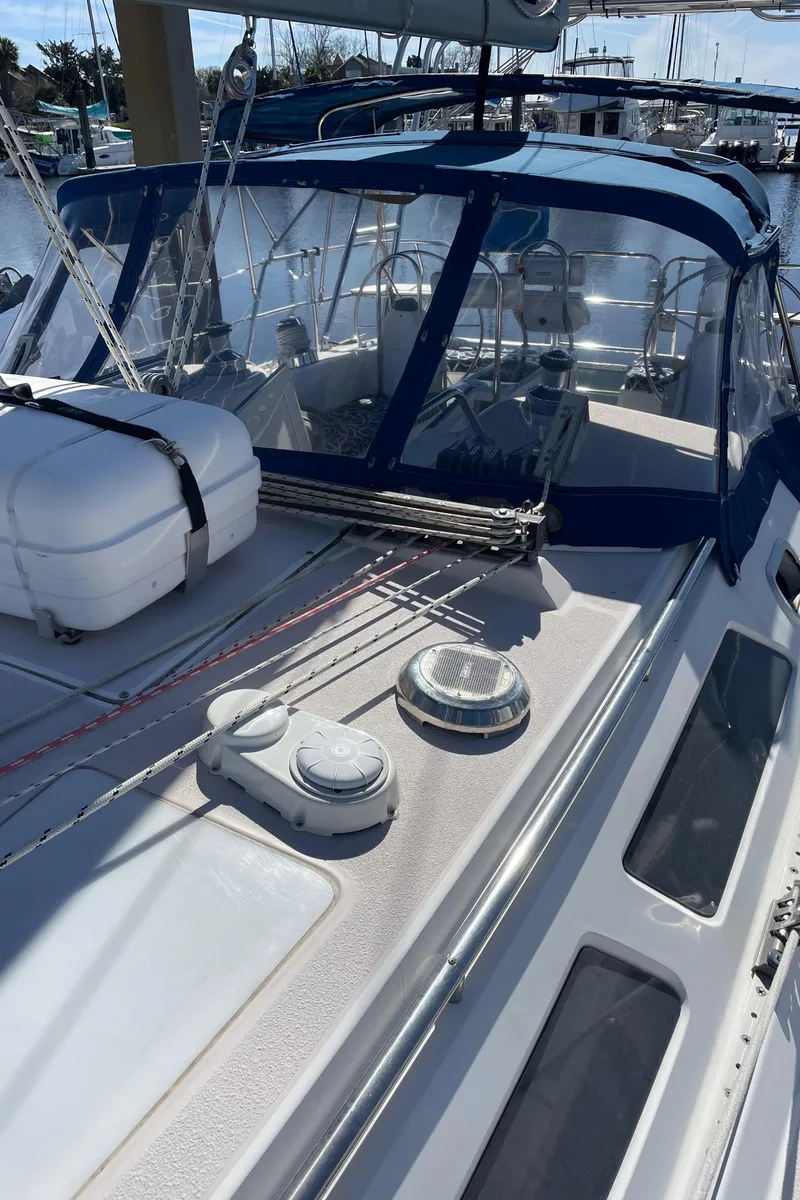 Slide: The Image of 1998 Catalina 400 sailboat deck with blue canopy and rigging details. - 36