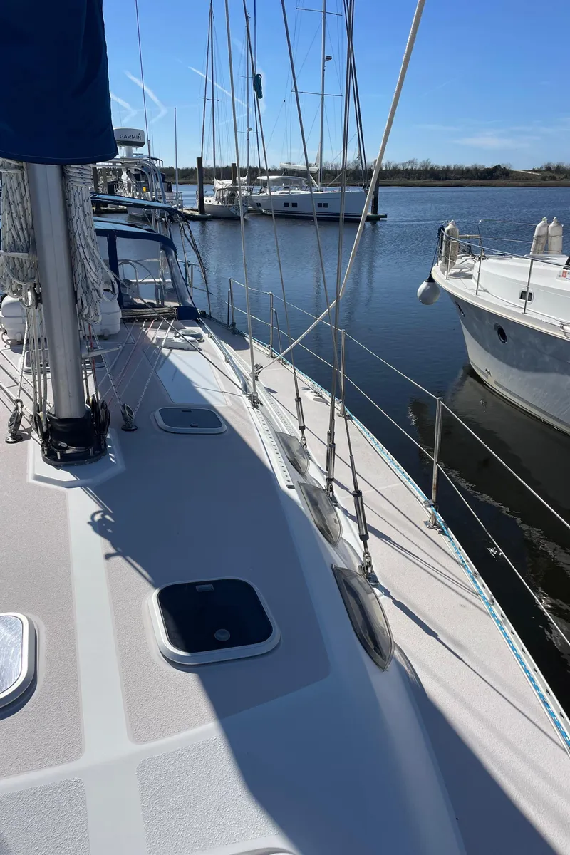Slide: The Image of 1998 Catalina 400 sailboat docked at marina, clear sky, calm water. - 37