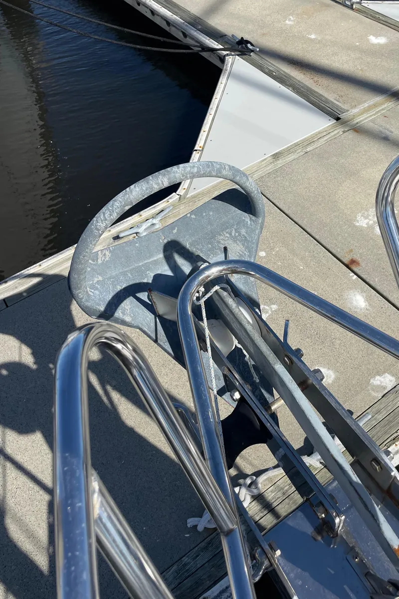 Slide: The Image of Close-up of a Catalina 400 sailboat's anchor and railing, docked at a marina. - 44