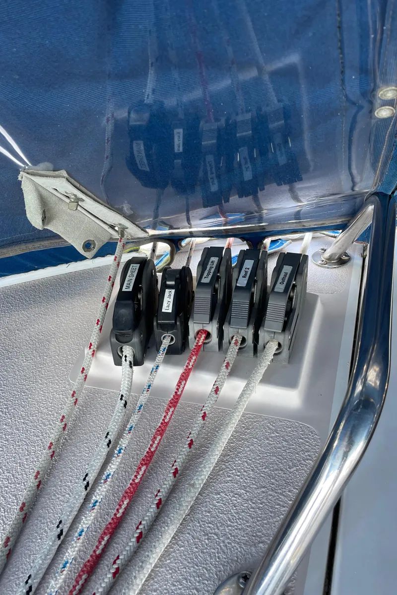 Slide: The Image of Close-up of Catalina 400 sailboat rope clutches, 1998 model, with colorful ropes and metal railing. - 48