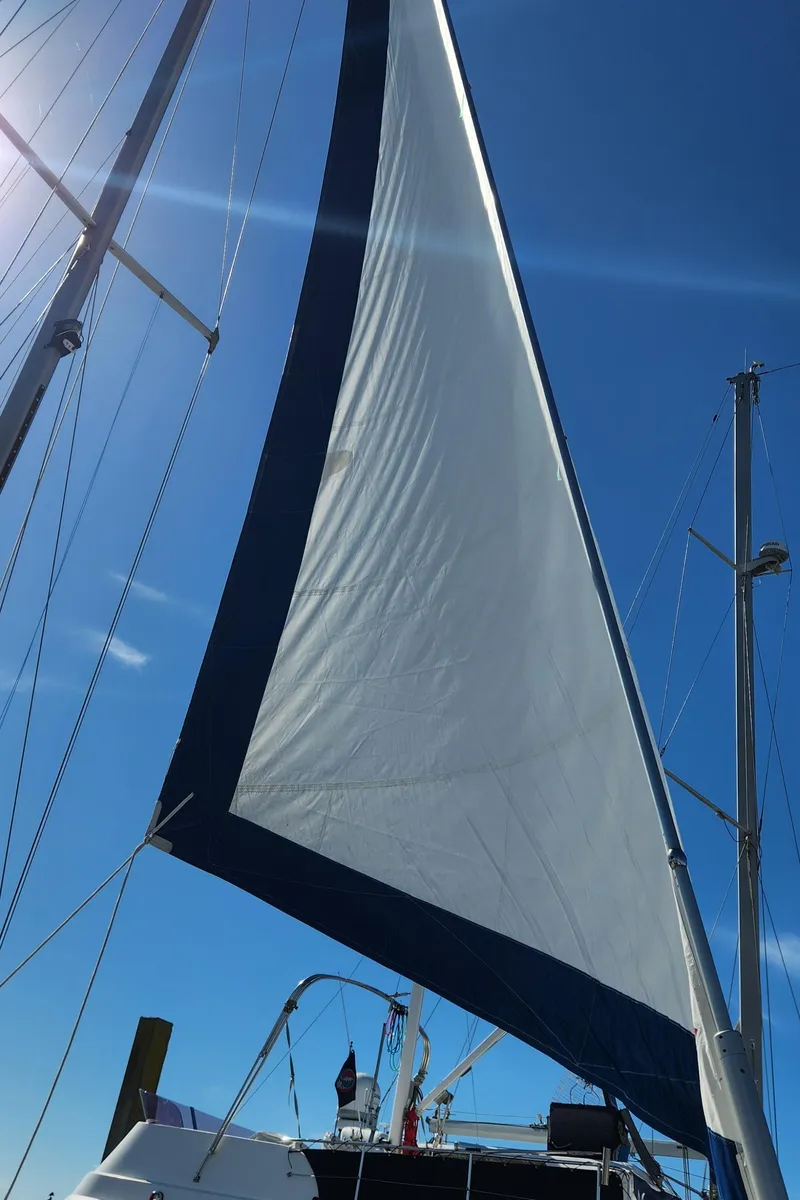Slide: The Image of Sailing yacht Catalina 400, 1998 model, with sails unfurled against a clear blue sky. - 5