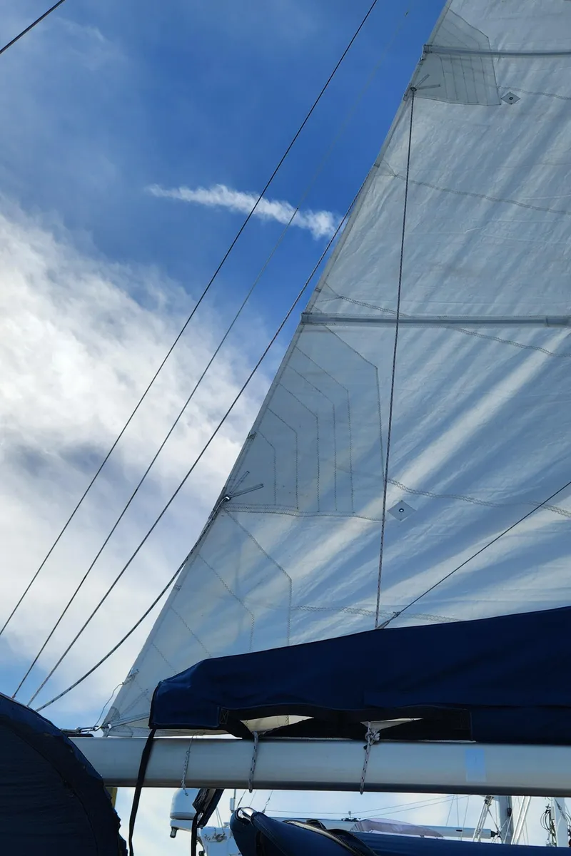 Slide: The Image of Sailboat with white sails against a blue sky, Catalina 400, 1998 model. - 9