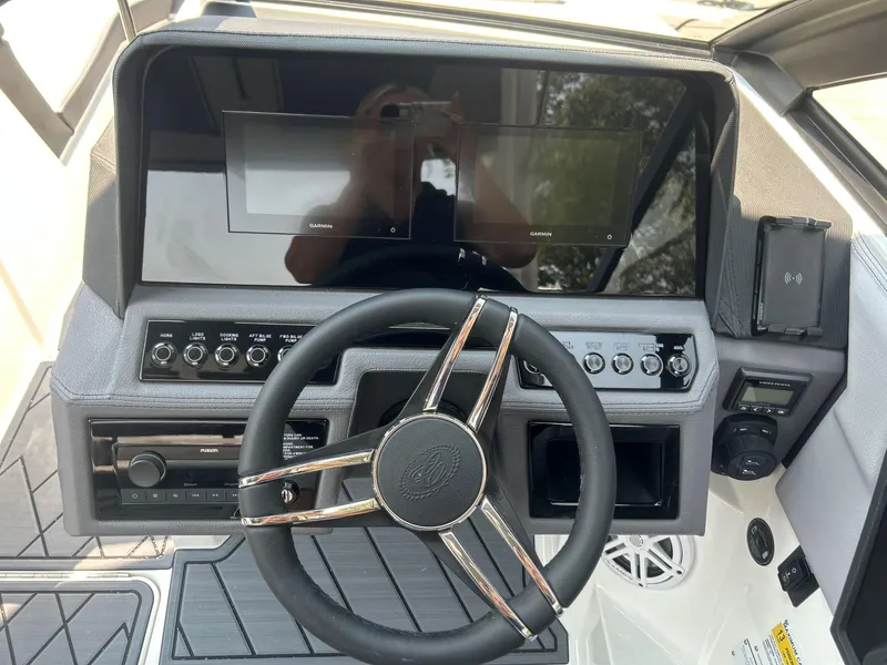Slide: The Image of 2026 Cobalt R4 boat dashboard with steering wheel, touchscreen displays, and control panel. - 12
