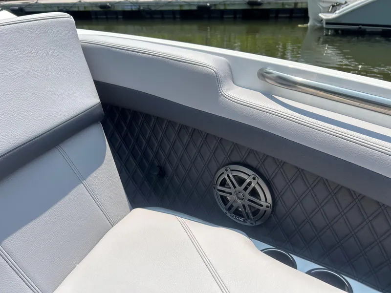 Slide: The Image of 2026 Cobalt R4 boat interior with quilted paneling, speaker, and cup holders. - 16