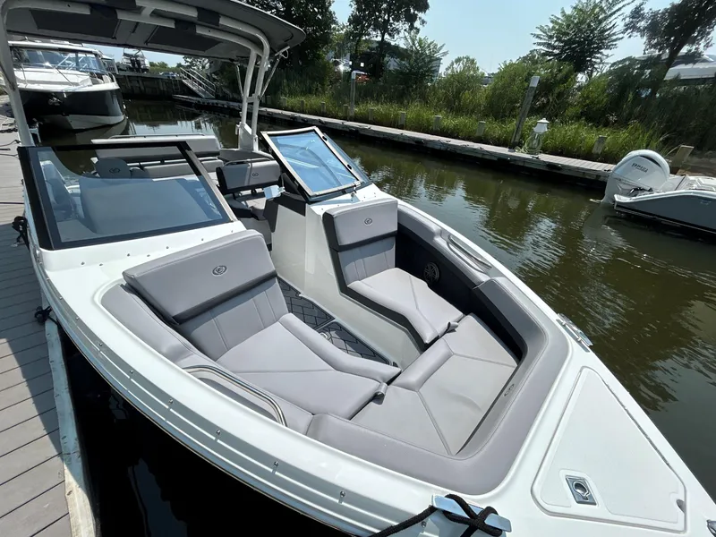 Slide: The Image of 2026 Cobalt R4 boat with sleek design, docked in a serene marina setting. - 19