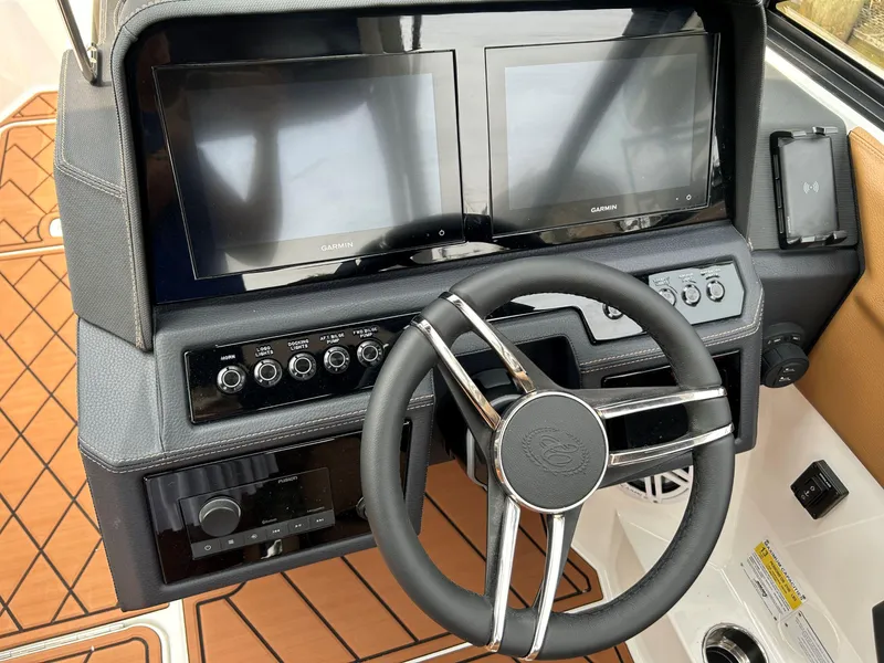 Slide: The Image of 2026 Cobalt R4 Outboard dashboard with dual Garmin displays and modern steering wheel. - 13