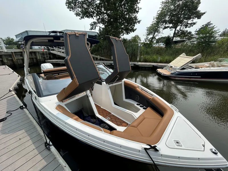 Slide: The Image of 2026 Cobalt R4 Outboard boat docked, featuring sleek design and comfortable seating. - 19