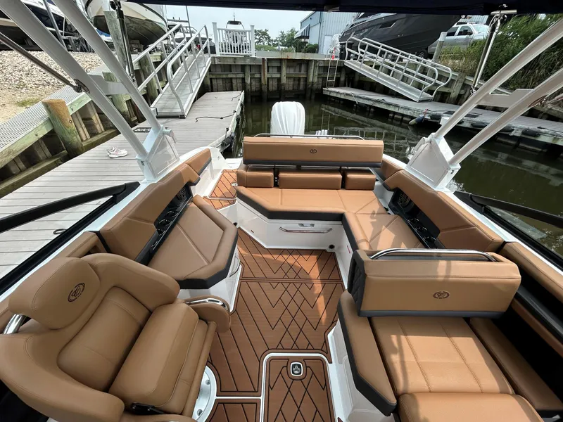 Slide: The Image of Luxurious interior of 2026 Cobalt R4 Outboard boat with tan leather seating and wood flooring. - 7