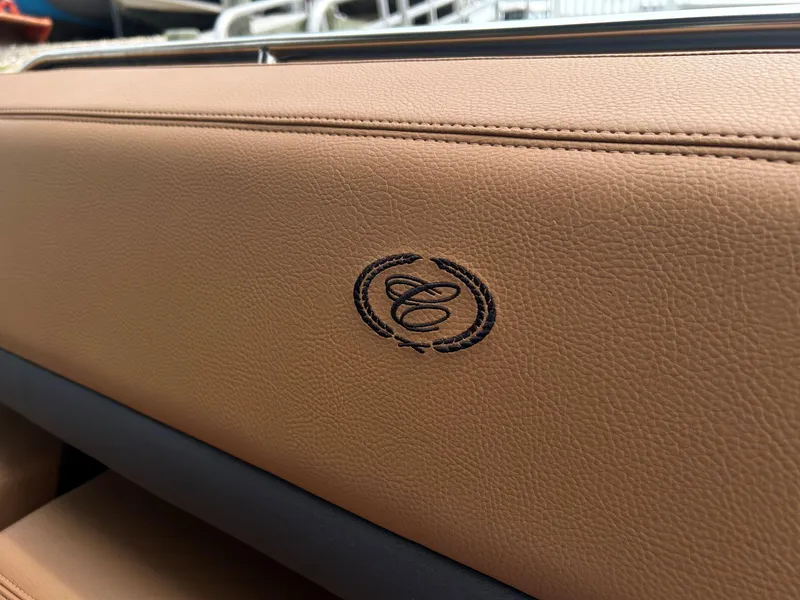 Slide: The Image of Luxurious tan leather interior of 2026 Cobalt R4 Outboard boat with embossed logo. - 8