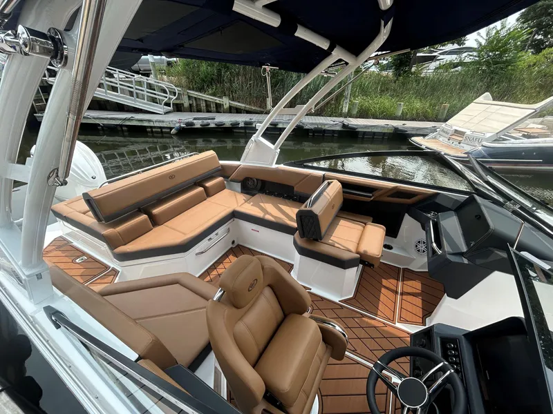 Slide: The Image of 2026 Cobalt R4 Outboard boat interior with tan leather seating and modern design. - 9