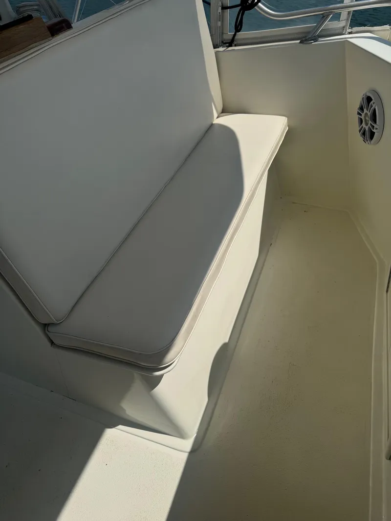 Slide: The Image of White cushioned seating on 1970 Hatteras 45 Convertible boat deck. - 10