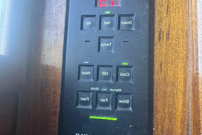 Slide: The Image of Control panel on a 1970 Hatteras 45 Convertible boat, featuring temperature and fan settings. - 11