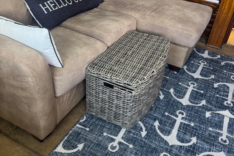 Slide: The Image of Cozy living area with wicker basket, beige sofa, and nautical anchor-themed rug. - 15