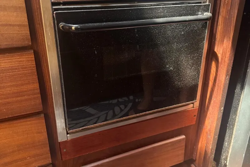 Slide: The Image of Wood-paneled oven in a 1970 Hatteras 45 Convertible yacht kitchen. - 16
