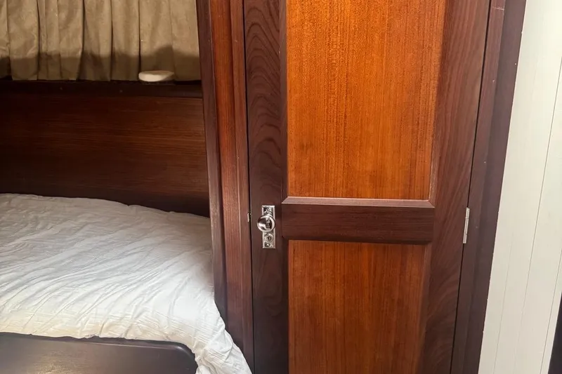 Slide: The Image of Interior cabin of 1970 Hatteras 45 Convertible with wooden door and bed. - 18