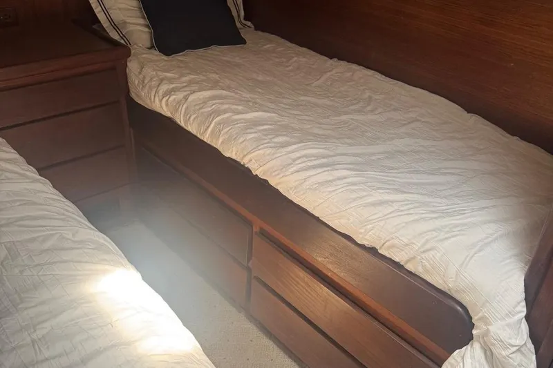 Slide: The Image of Interior cabin of 1970 Hatteras 45 Convertible with twin beds and wooden furnishings. - 19