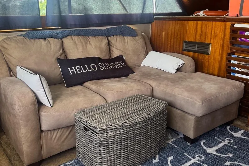 Slide: The Image of Cozy interior of 1970 Hatteras 45 Convertible with beige sofa and nautical decor. - 31