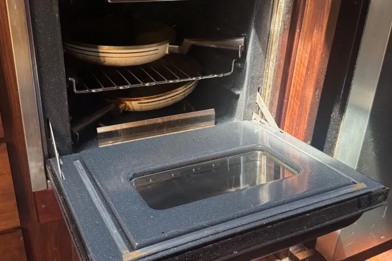 Slide: The Image of Open oven with stacked pans inside, aboard a 1970 Hatteras 45 Convertible yacht. - 35