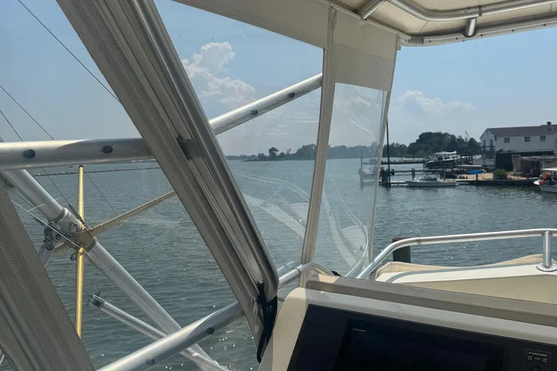Slide: The Image of View from 1970 Hatteras 45 Convertible boat, overlooking serene waterfront and docks. - 6