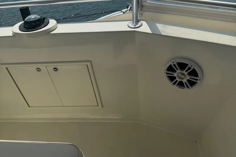 Slide: The Image of 1970 Hatteras 45 Convertible boat interior with compass, speaker, and storage compartment. - 9