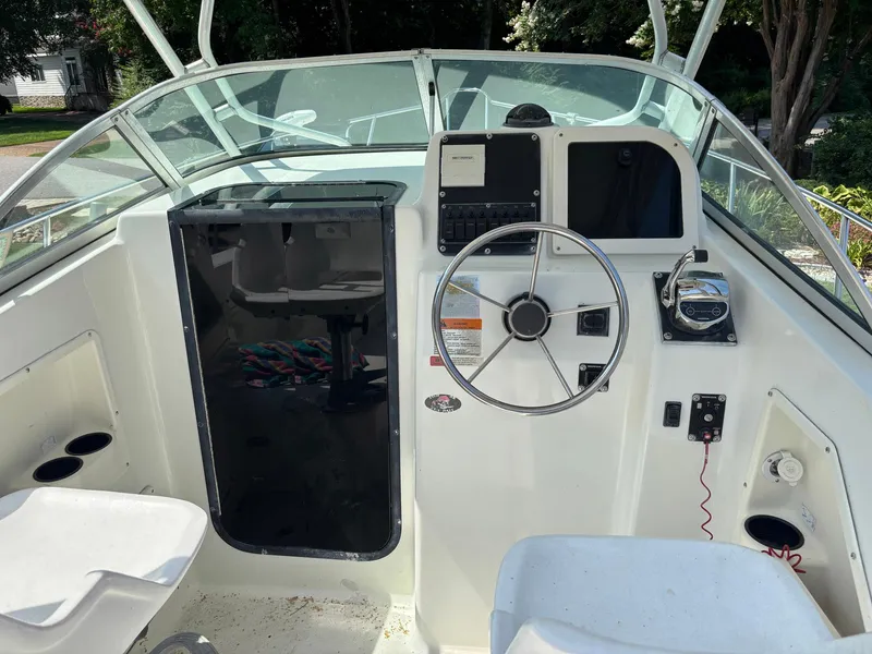 Slide: The Image of 2000 Hydra-Sports 230 Seahorse WA boat cockpit with steering wheel and control panel. - 5