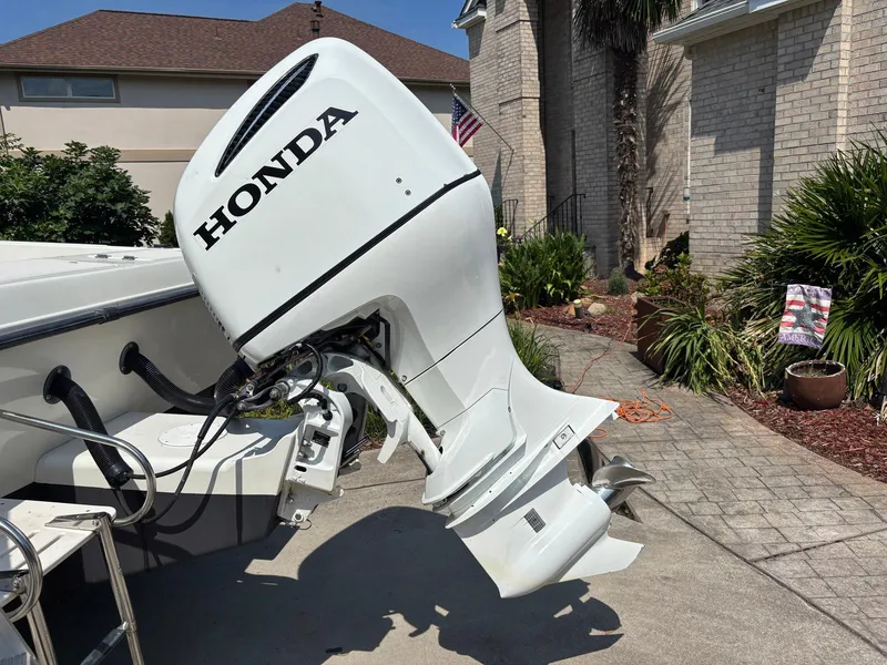 Slide: The Image of 2000 Hydra-Sports 230 Seahorse WA with Honda outboard motor in driveway setting. - 7