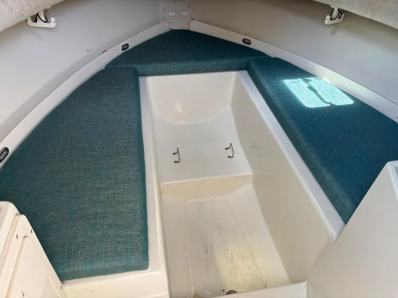 Slide: The Image of 2000 Hydra-Sports 230 Seahorse WA cabin interior with teal cushions. - 9