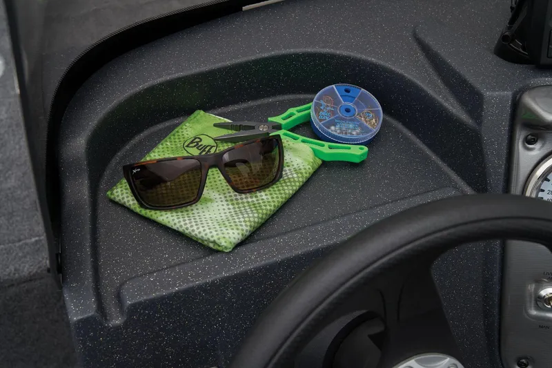 Slide: The Image of Manufacturer Provided Image: Sunglasses and fishing gear on 2026 Tracker Pro Guide V-16 SC boat dashboard. - 30