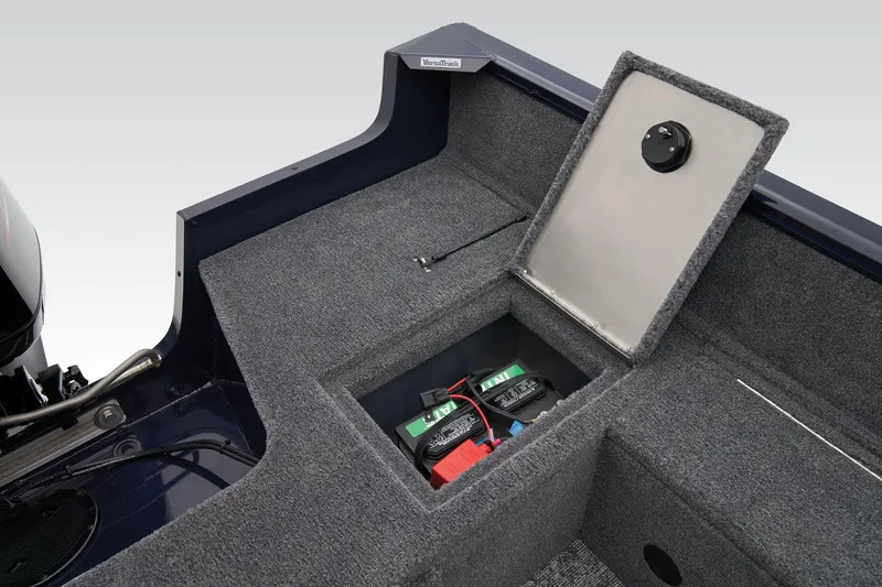 Slide: The Image of Manufacturer Provided Image: 2026 Tracker Pro Guide V-16 SC boat storage compartment with battery, gray carpet interior. - 42