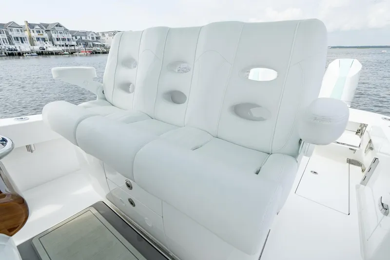 Slide: The Image of 2024 Valhalla Boatworks V-37 luxurious white seating on deck, waterfront view. - 12