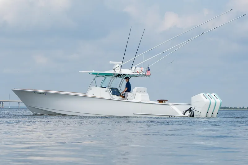 Slide: The Image of 2024 Valhalla Boatworks V-37 on water, featuring triple outboard engines and fishing rods. - 4