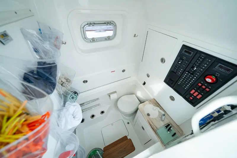 Slide: The Image of 2024 Valhalla Boatworks V-37 cabin interior with control panel and compact amenities. - 9