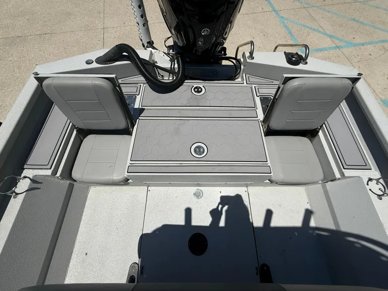 Slide: The Image of 2022 Avid 23 Fusion Platinum boat interior with gray seating and storage compartments. - 12