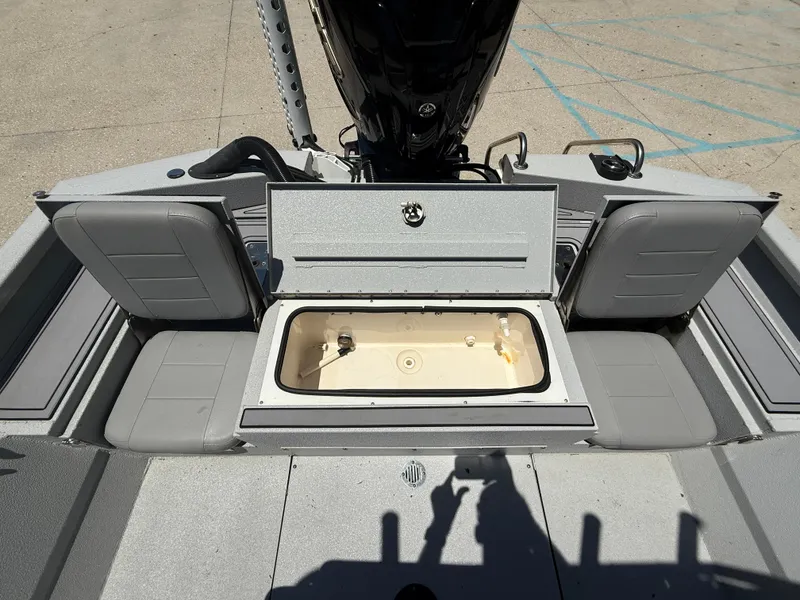 Slide: The Image of 2022 Avid 23 Fusion Platinum boat interior with open storage compartment and seating. - 13