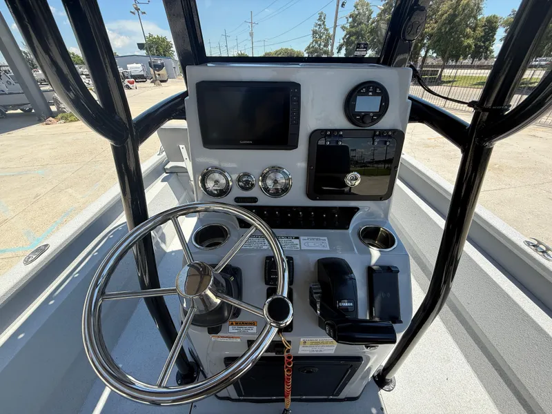 Slide: The Image of Avid 23 Fusion Platinum 2022 boat console with steering wheel and navigation controls. - 14