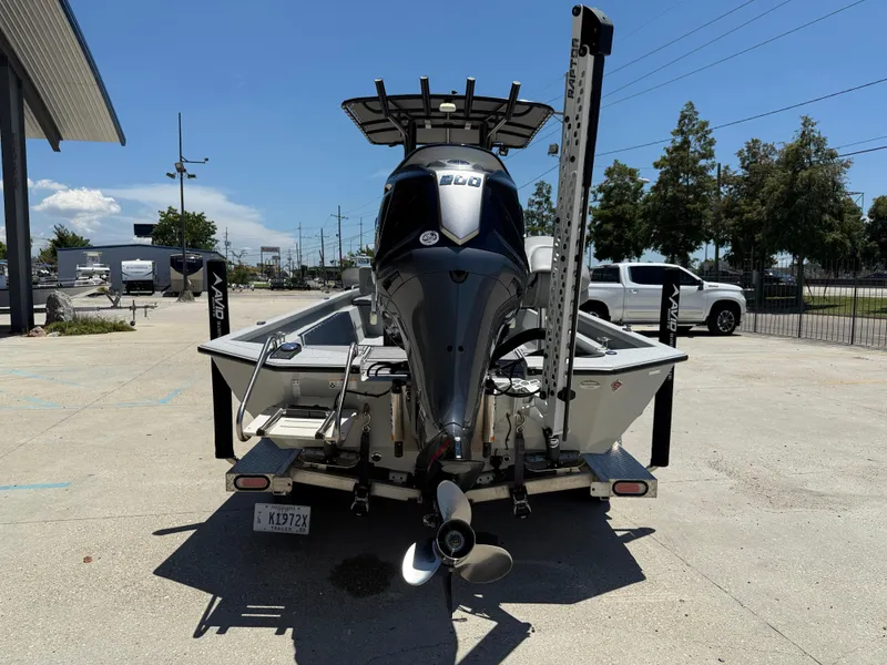 Slide: The Image of 2022 Avid 23 Fusion Platinum boat with powerful outboard motor, parked outdoors. - 5