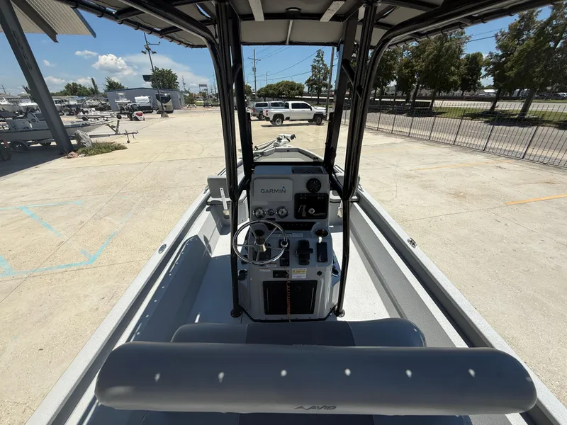 Slide: The Image of 2022 Avid 23 Fusion Platinum boat interior with steering console and Garmin navigation system. - 7