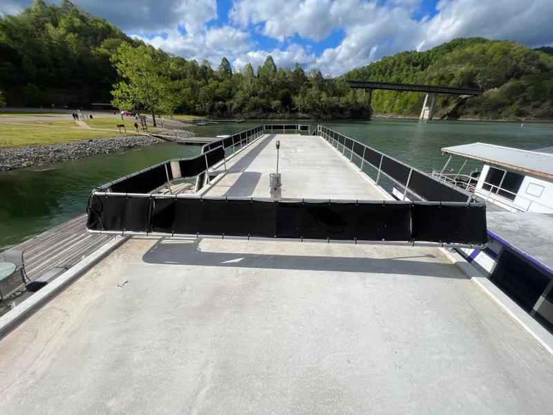 Slide: The Image of 1993 Sumerset houseboat docked on a scenic river with lush green surroundings. - 19