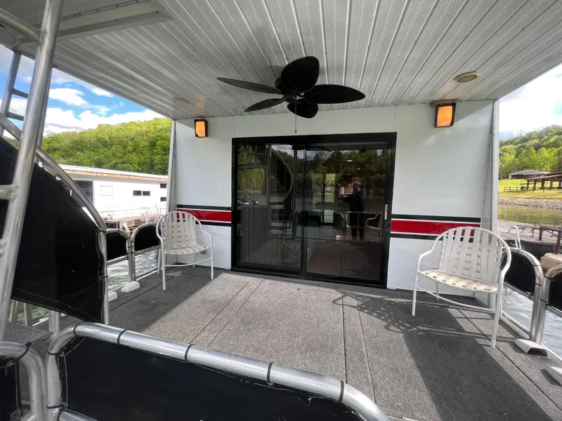 Slide: The Image of 1993 Sumerset houseboat deck with chairs, ceiling fan, and sliding glass doors. - 20